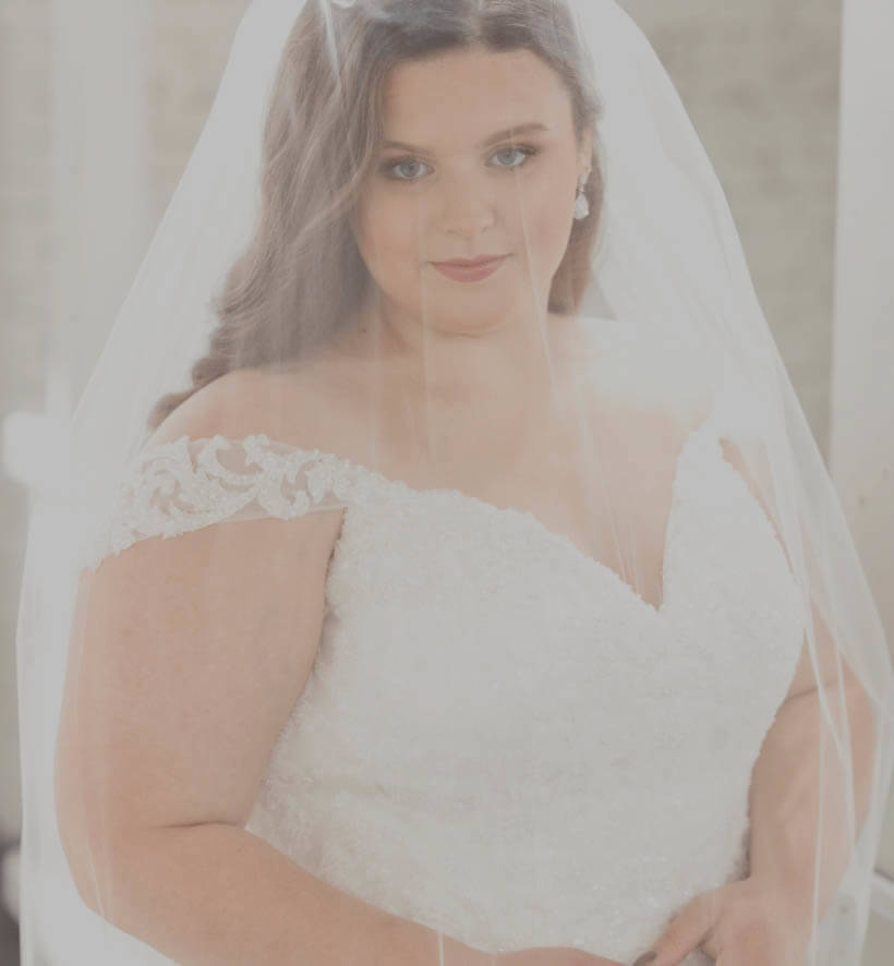 Model plus size wearing a white gown