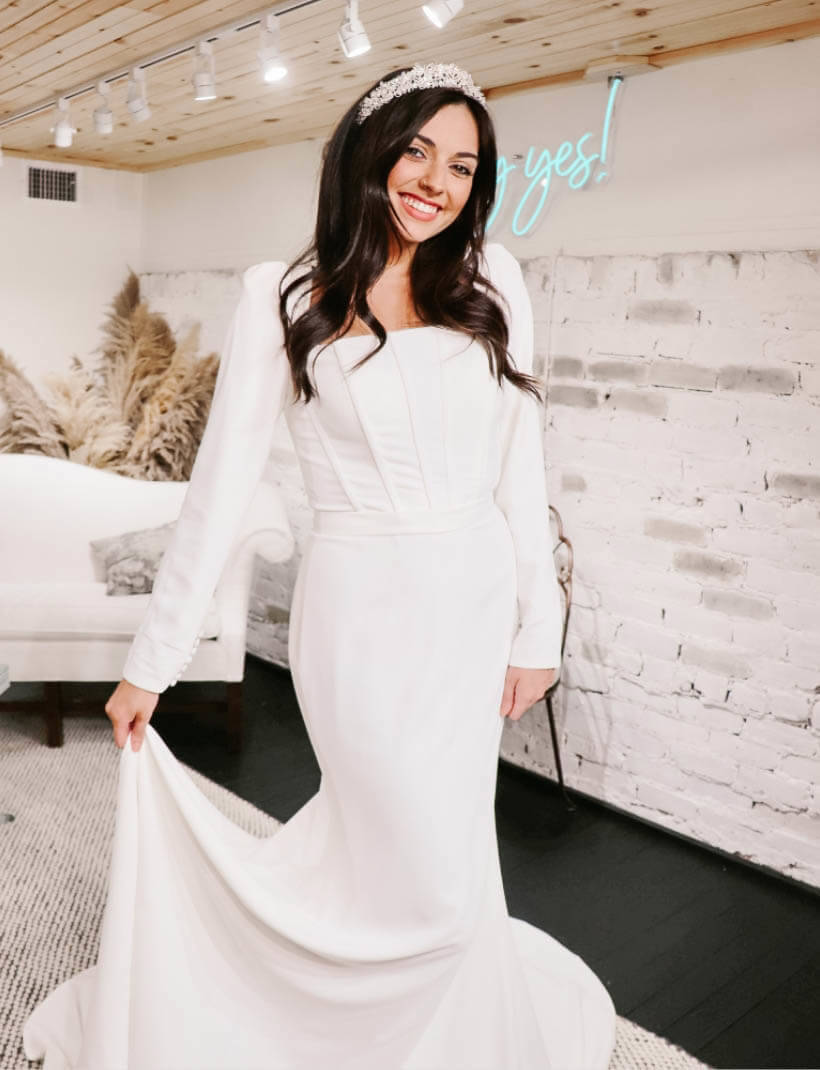 Smiling model wearing a white gown