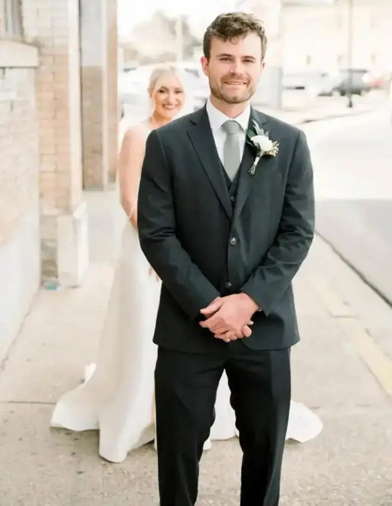 Сouple wearing a white gown and a black suit